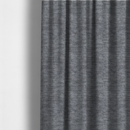 The fabric used to create these made-to-measure curtains is a dark charcoal grey fabric with a dense horizontal ribbed texture. The weave features a soft, plush pile with subtle weathered variations, creating a multi-tonal smoky effect that adds depth and a sophisticated matte finish.