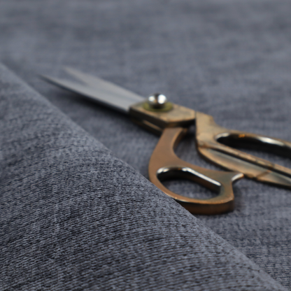 A deep navy-charcoal fabric with a dense horizontal ribbed texture. The material has a soft, plush pile that creates a subtle multi-tonal effect, blending dark midnight blue and charcoal grey tones with a durable matte finish.