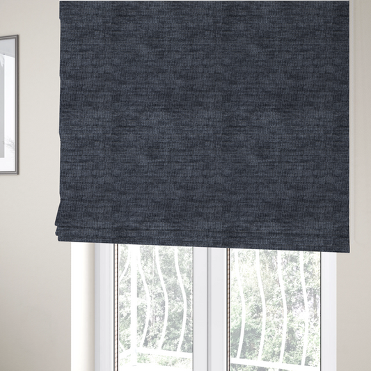 The fabric used to create these Roman blinds is a deep navy-charcoal fabric with a dense horizontal ribbed texture. The material has a soft, plush pile that creates a subtle multi-tonal effect, blending dark midnight blue and charcoal grey tones with a durable matte finish.