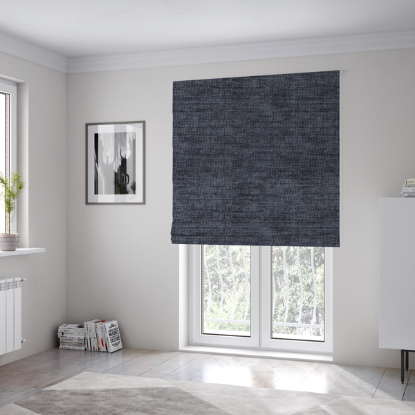 The fabric used to create these Roman blinds is a deep navy-charcoal fabric with a dense horizontal ribbed texture. The material has a soft, plush pile that creates a subtle multi-tonal effect, blending dark midnight blue and charcoal grey tones with a durable matte finish.