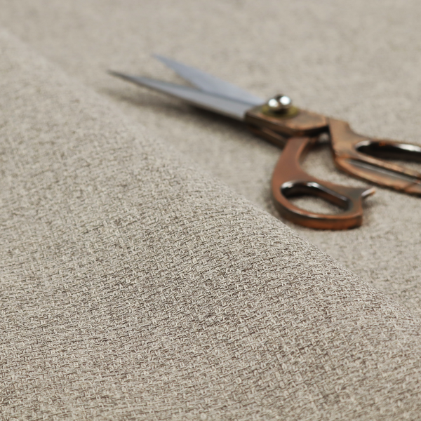 An upholstery fabric in a versatile taupe or mushroom shade. The textile features a dense, multi-tonal weave with interlacing fibres of cool grey, beige, and cream, creating a sophisticated textured linen-look surface.