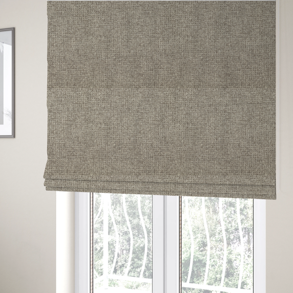 The fabric used to create these Roman blinds is a upholstery fabric in a versatile taupe or mushroom shade. The textile features a dense, multi-tonal weave with interlacing fibres of cool grey, beige, and cream, creating a sophisticated textured linen-look surface.