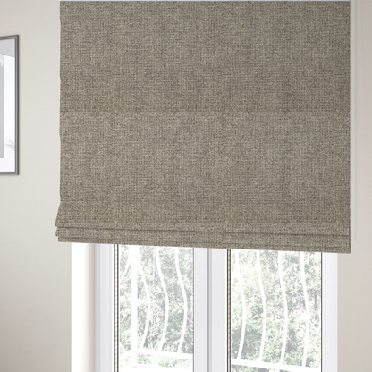 The fabric used to create these Roman blinds is a upholstery fabric in a versatile taupe or mushroom shade. The textile features a dense, multi-tonal weave with interlacing fibres of cool grey, beige, and cream, creating a sophisticated textured linen-look surface.