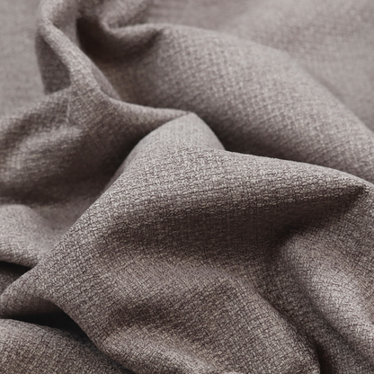 An upholstery fabric in a sophisticated mink or warm grey shade. The textile features a tight, multi-tonal weave with interlacing threads of deep taupe, charcoal, and soft brown, creating a rich, textured surface with a matte finish.