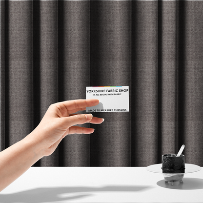 The fabric used to create these made-to-measure curtains is a upholstery fabric in a sophisticated mink or warm grey shade. The textile features a tight, multi-tonal weave with interlacing threads of deep taupe, charcoal, and soft brown, creating a rich, textured surface with a matte finish.