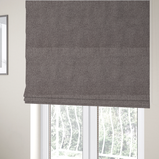 The fabric used to create these Roman blinds is a upholstery fabric in a sophisticated mink or warm grey shade. The textile features a tight, multi-tonal weave with interlacing threads of deep taupe, charcoal, and soft brown, creating a rich, textured surface with a matte finish.