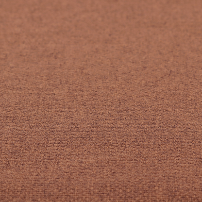 An upholstery fabric in a warm terracotta or burnt orange shade. The textile features a multi-tonal basket weave with interlacing copper and dark brown threads, creating a rich, textured linen-look surface with an earthy, matte finish.