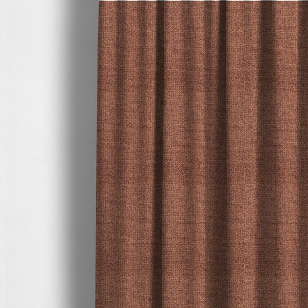 The fabric used to create these made-to-measure curtains is a upholstery fabric in a warm terracotta or burnt orange shade. The textile features a multi-tonal basket weave with interlacing copper and dark brown threads, creating a rich, textured linen-look surface with an earthy, matte finish.
