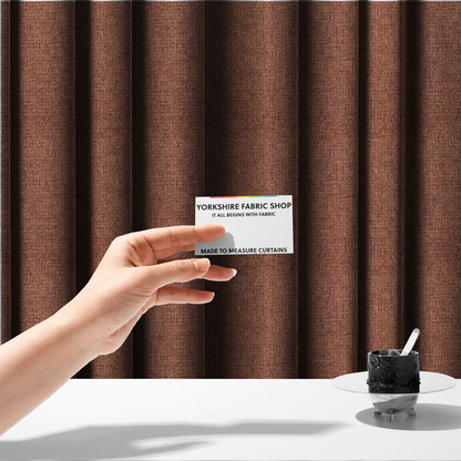 The fabric used to create these made-to-measure curtains is a upholstery fabric in a warm terracotta or burnt orange shade. The textile features a multi-tonal basket weave with interlacing copper and dark brown threads, creating a rich, textured linen-look surface with an earthy, matte finish.