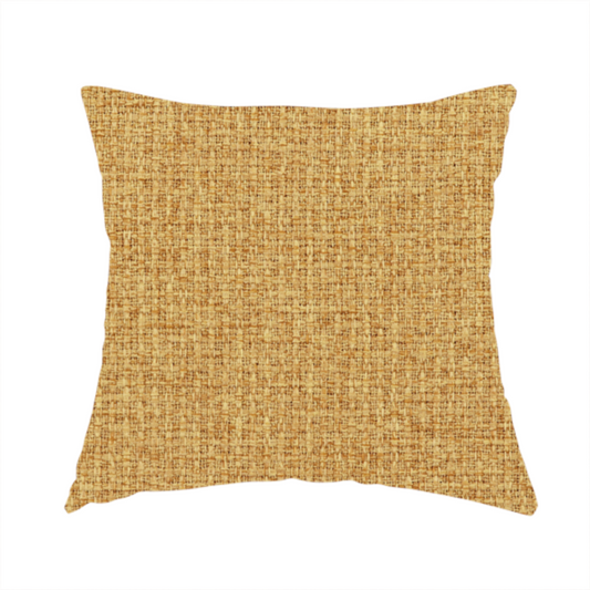 The fabric used to create these handmade cushions is a upholstery fabric in a bright mustard or golden ochre shade. The textile features a dense, multi-tonal basket weave with interlacing threads of yellow, gold, and light tan, creating a vibrant, linen-look texture with a matte finish.