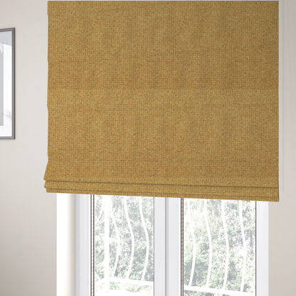 The fabric used to create these Roman blinds is a upholstery fabric in a bright mustard or golden ochre shade. The textile features a dense, multi-tonal basket weave with interlacing threads of yellow, gold, and light tan, creating a vibrant, linen-look texture with a matte finish.