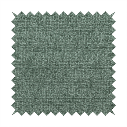 An upholstery fabric in a serene seafoam or muted teal shade. The textile features a dense, multi-tonal weave with interlacing threads of dusty blue-green and dark charcoal, creating a textured, linen-look surface with a matte finish.