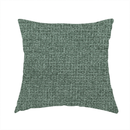 The fabric used to create this handmade cushion is a upholstery fabric in a serene seafoam or muted teal shade. The textile features a dense, multi-tonal weave with interlacing threads of dusty blue-green and dark charcoal, creating a textured, linen-look surface with a matte finish.
