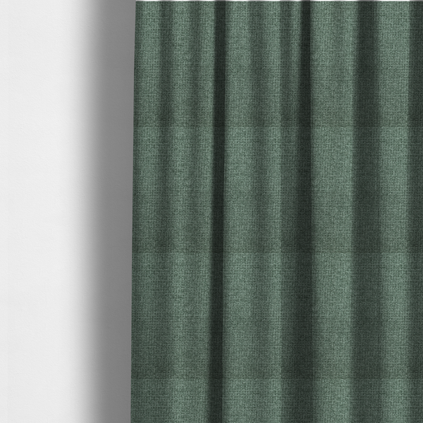 The fabric used to create these made-to-measure curtains is a upholstery fabric in a serene seafoam or muted teal shade. The textile features a dense, multi-tonal weave with interlacing threads of dusty blue-green and dark charcoal, creating a textured, linen-look surface with a matte finish.