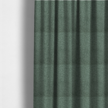 The fabric used to create these made-to-measure curtains is a upholstery fabric in a serene seafoam or muted teal shade. The textile features a dense, multi-tonal weave with interlacing threads of dusty blue-green and dark charcoal, creating a textured, linen-look surface with a matte finish.