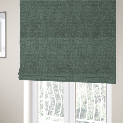 The fabric used to create these Roman blinds is a upholstery fabric in a serene seafoam or muted teal shade. The textile features a dense, multi-tonal weave with interlacing threads of dusty blue-green and dark charcoal, creating a textured, linen-look surface with a matte finish.