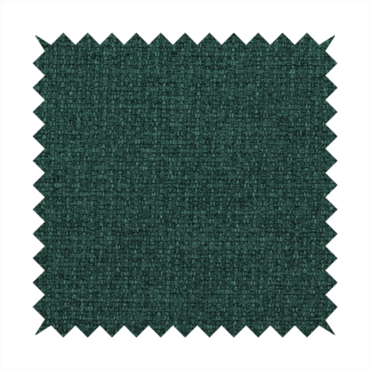 An upholstery fabric in a deep forest or emerald green shade. The textile features a dense, multi-tonal weave with interlaced threads of dark teal and charcoal, creating a rich, textured linen-look surface with a sophisticated matte finish.