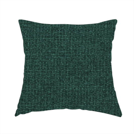 The fabric used to create handmade cushions is a upholstery fabric in a deep forest or emerald green shade. The textile features a dense, multi-tonal weave with interlaced threads of dark teal and charcoal, creating a rich, textured linen-look surface with a sophisticated matte finish.