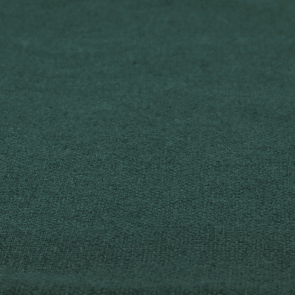 An upholstery fabric in a deep forest or emerald green shade. The textile features a dense, multi-tonal weave with interlaced threads of dark teal and charcoal, creating a rich, textured linen-look surface with a sophisticated matte finish.