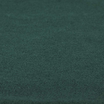 An upholstery fabric in a deep forest or emerald green shade. The textile features a dense, multi-tonal weave with interlaced threads of dark teal and charcoal, creating a rich, textured linen-look surface with a sophisticated matte finish.