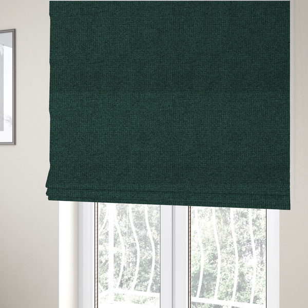 The fabric used to create these Roman blinds is a upholstery fabric in a deep forest or emerald green shade. The textile features a dense, multi-tonal weave with interlaced threads of dark teal and charcoal, creating a rich, textured linen-look surface with a sophisticated matte finish.