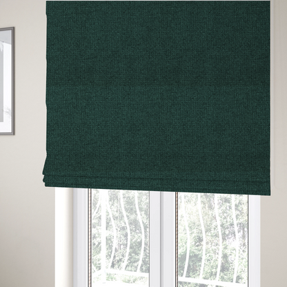 The fabric used to create these Roman blinds is a upholstery fabric in a deep forest or emerald green shade. The textile features a dense, multi-tonal weave with interlaced threads of dark teal and charcoal, creating a rich, textured linen-look surface with a sophisticated matte finish.