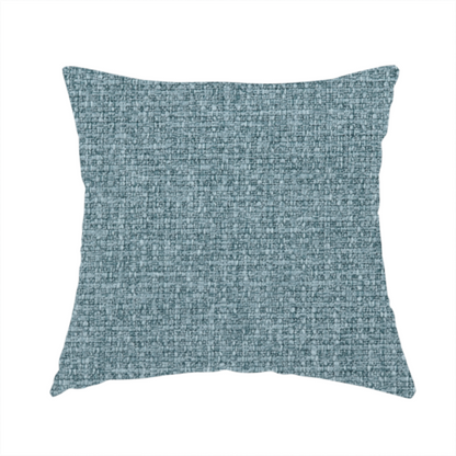 The fabric used to create these handmade cushions is a upholstery fabric in a soft slate blue or dusty denim shade. The textile features a dense, multi-tonal basket weave with interlaced threads of sky blue, muted grey, and charcoal, creating a textured, linen-look surface with a matte finish.