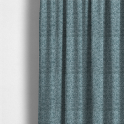 The fabric used to create these made-to-measure curtains is a upholstery fabric in a soft slate blue or dusty denim shade. The textile features a dense, multi-tonal basket weave with interlaced threads of sky blue, muted grey, and charcoal, creating a textured, linen-look surface with a matte finish.