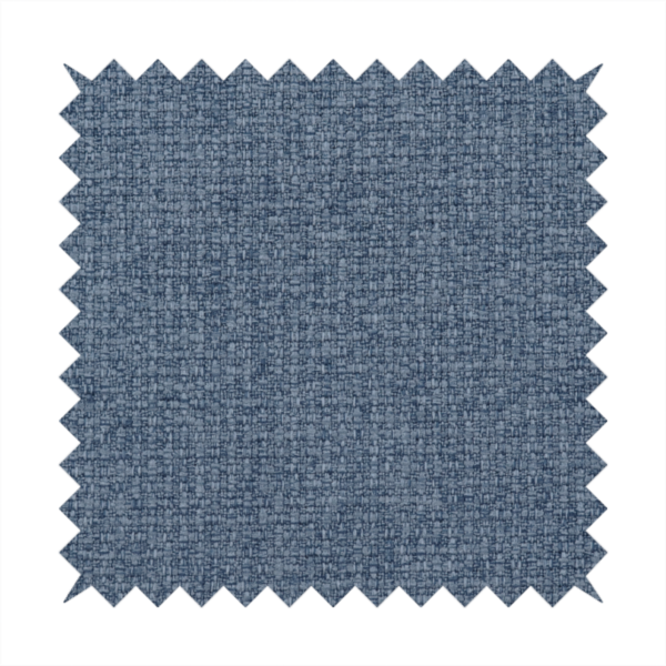 An upholstery fabric in a classic navy or denim blue. The textile features a dense, multi-tonal weave with interlacing threads of royal blue, charcoal, and soft grey, creating a rich, textured linen-look surface with a matte finish.