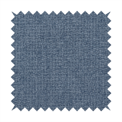 An upholstery fabric in a classic navy or denim blue. The textile features a dense, multi-tonal weave with interlacing threads of royal blue, charcoal, and soft grey, creating a rich, textured linen-look surface with a matte finish.