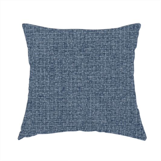 The fabric used to create this handmade cushion is a upholstery fabric in a classic navy or denim blue. The textile features a dense, multi-tonal weave with interlacing threads of royal blue, charcoal, and soft grey, creating a rich, textured linen-look surface with a matte finish.