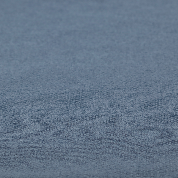 An upholstery fabric in a classic navy or denim blue. The textile features a dense, multi-tonal weave with interlacing threads of royal blue, charcoal, and soft grey, creating a rich, textured linen-look surface with a matte finish.