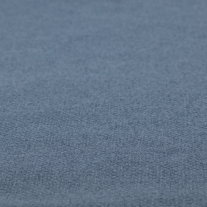 An upholstery fabric in a classic navy or denim blue. The textile features a dense, multi-tonal weave with interlacing threads of royal blue, charcoal, and soft grey, creating a rich, textured linen-look surface with a matte finish.