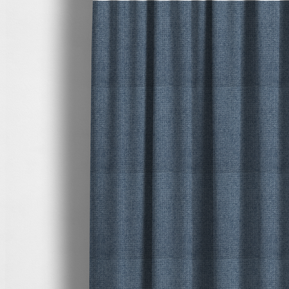 The fabric used to create these made-to-measure curtains is a upholstery fabric in a classic navy or denim blue. The textile features a dense, multi-tonal weave with interlacing threads of royal blue, charcoal, and soft grey, creating a rich, textured linen-look surface with a matte finish.