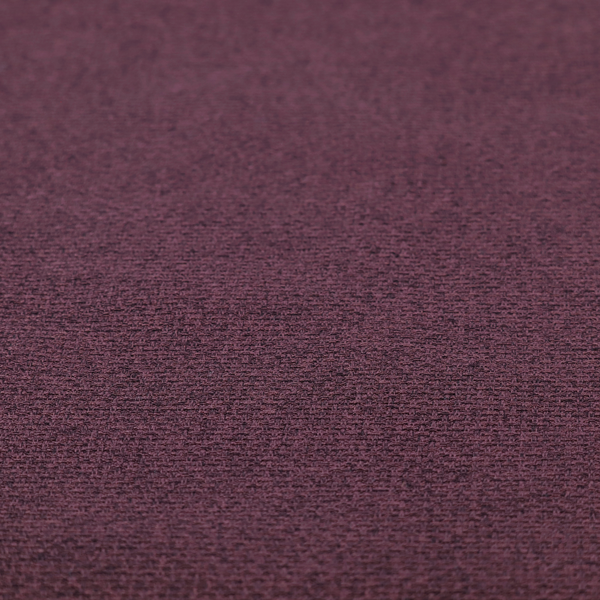 an upholstery fabric in a rich plum or deep burgundy shade. The textile features a dense, multi-tonal weave with interlacing threads of dark purple, berry, and charcoal, creating a textured, linen-look surface with a sophisticated matte finish.