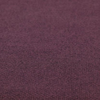 an upholstery fabric in a rich plum or deep burgundy shade. The textile features a dense, multi-tonal weave with interlacing threads of dark purple, berry, and charcoal, creating a textured, linen-look surface with a sophisticated matte finish.