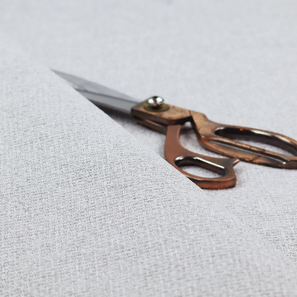 A fabric in a cool-toned light silver or pale grey. The weave features interlaced white and soft grey threads, creating a bright, contemporary textured finish.