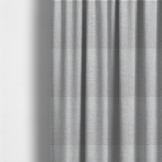 The fabric used to create these made-to-measure curtains is a fabric in a cool-toned light silver or pale grey. The weave features interlaced white and soft grey threads, creating a bright, contemporary textured finish.