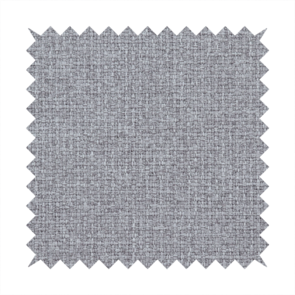 An upholstery fabric in a cool pebble grey. The interlacing of light grey and off-white threads creates a clean, contemporary basket weave pattern with a matte finish.