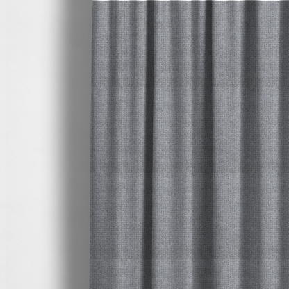 The fabric used to create these made-to-measure curtains is a upholstery fabric in a cool pebble grey. The interlacing of light grey and off-white threads creates a clean, contemporary basket weave pattern with a matte finish.