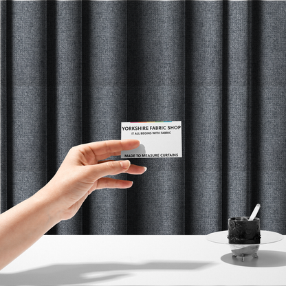 The fabric used to create these made-to-measure curtains is a fabric in a dark steel or charcoal grey. The high-contrast weave features interlaced light grey and deep black fibres, creating a rugged, textured surface.