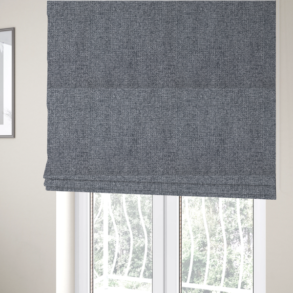 The fabric used to create these Roman blinds is a fabric in a dark steel or charcoal grey. The high-contrast weave features interlaced light grey and deep black fibres, creating a rugged, textured surface.