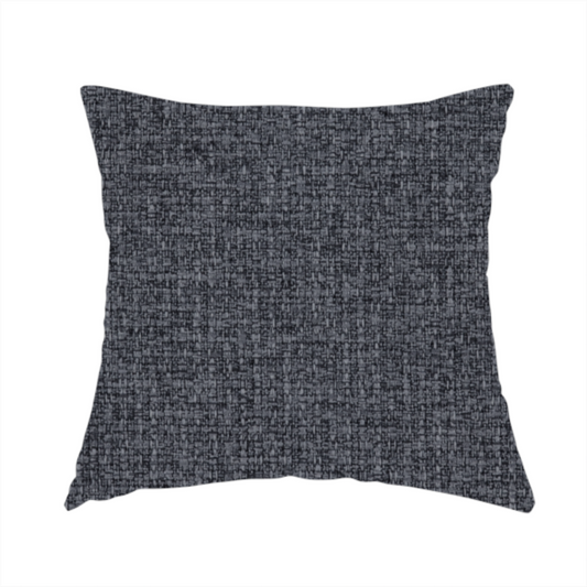 The fabric used to create this handmade cushion is a fabric in a deep charcoal or carbon grey. The high-contrast weave features heavily interlaced black and slate grey fibres for a dense, rugged texture.