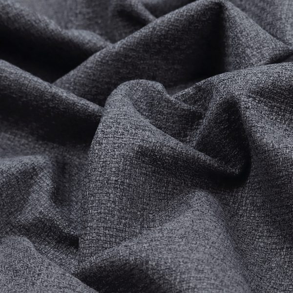 A fabric in a deep charcoal or carbon grey. The high-contrast weave features heavily interlaced black and slate grey fibres for a dense, rugged texture.