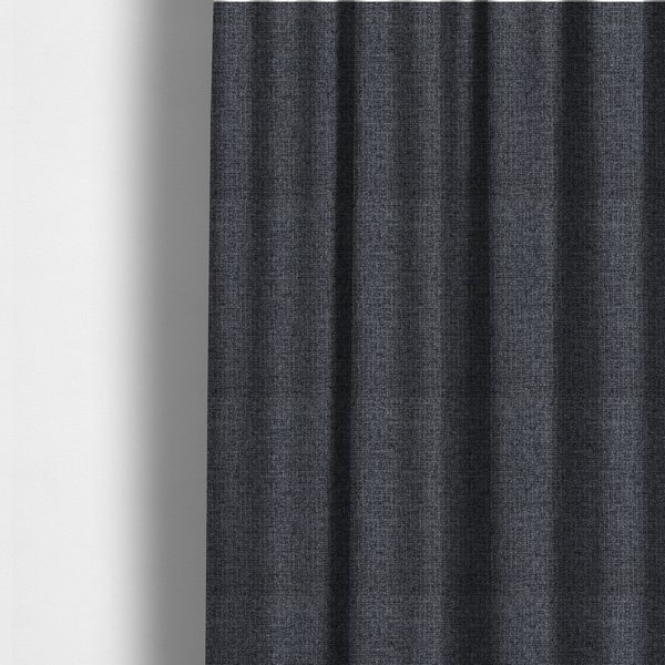 The fabric used to create these made-to-measure curtains is a fabric in a deep charcoal or carbon grey. The high-contrast weave features heavily interlaced black and slate grey fibres for a dense, rugged texture.