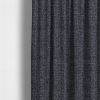 The fabric used to create these made-to-measure curtains is a fabric in a deep charcoal or carbon grey. The high-contrast weave features heavily interlaced black and slate grey fibres for a dense, rugged texture.