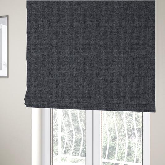 The fabric used to create these Roman blinds is a fabric in a deep charcoal or carbon grey. The high-contrast weave features heavily interlaced black and slate grey fibres for a dense, rugged texture.