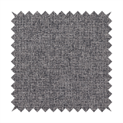 A fabric in storm grey. A balanced mid-to-dark grey weave featuring a complex interlacing of ash and soot.