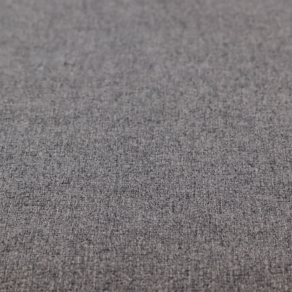 A fabric in storm grey. A balanced mid-to-dark grey weave featuring a complex interlacing of ash and soot.