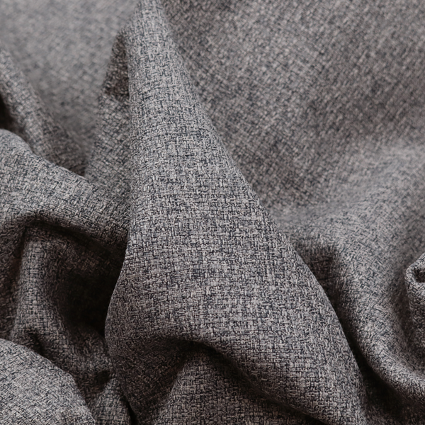 A fabric in storm grey. A balanced mid-to-dark grey weave featuring a complex interlacing of ash and soot.